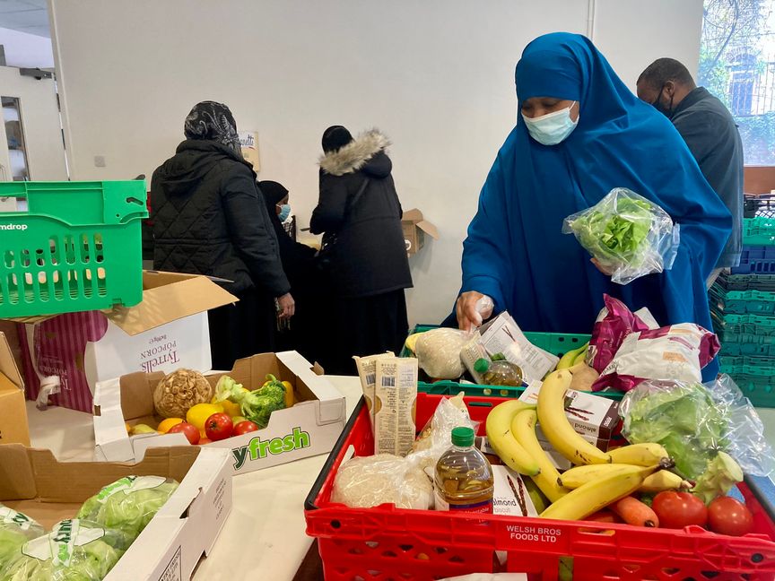 Organisers packing food into boxes.